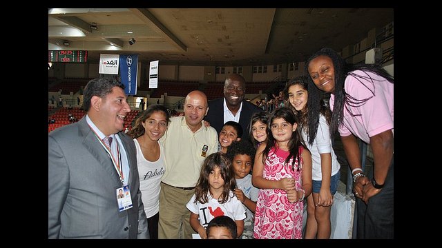 Andrea Stinson and Sam Vincent pose with young Jordanian fans.