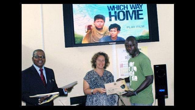 Filmmaker, Kim Snyder, presents a certificate to a Nigerian workshop participant.