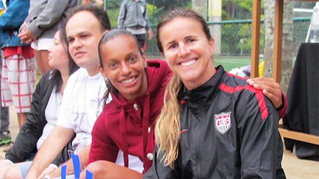 Brandi Chastain poses with Rosana dos Santos Augusto at a Soccer Festival in celebration of the positive things that come with participation in sports.