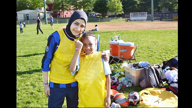 An Egyptian soccer coach poses with another participant at a United for DC volunteer session.