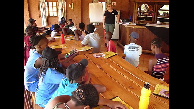 An English Language Fellow facilitates a session at a summer camp in South Africa.