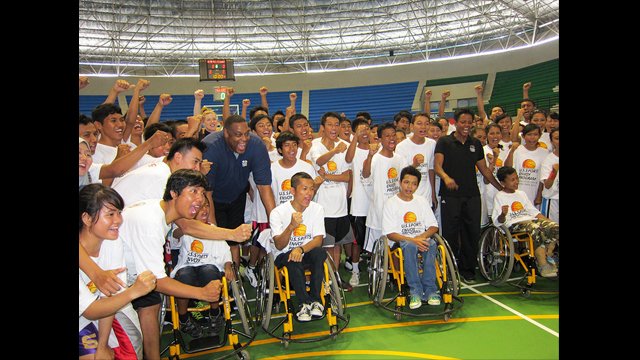 Rick Mahorn and Edna Campbell at a wheelchair basketball coaching clinic with young Indonesians from the Yakkum Rehabilitation Center.