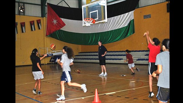 Marty Conlon coaches young Jordanians during their basketball drills.