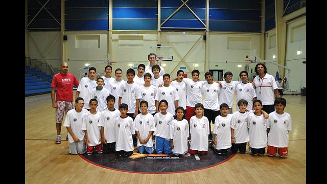 Marty Conlon poses with a group of young athletes in Jordan.