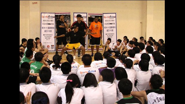 Kiesha Brown demonstrates a blocking pose for students during a Q&A session.
