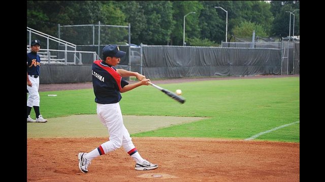 One of the Japanese participants perfects his batting skills.