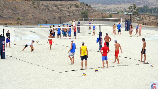 Groups of young athletes work out on the training courts.