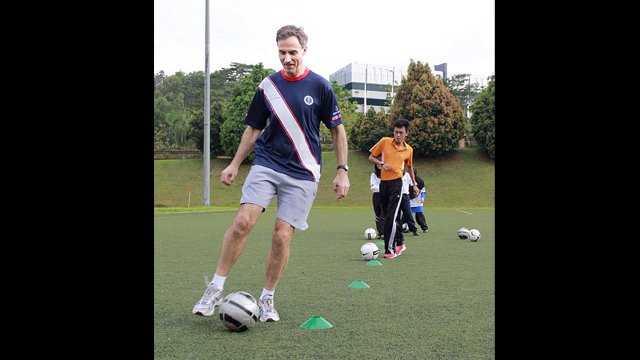 U.S. Ambassador to Malaysia, Paul Jones, shows off his footwork in a soccer clinic.