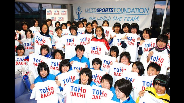 These young girls hold up their "TOMODACHI" shirts to represent the initiative to strengthen the friendship between Japan and the U.S.