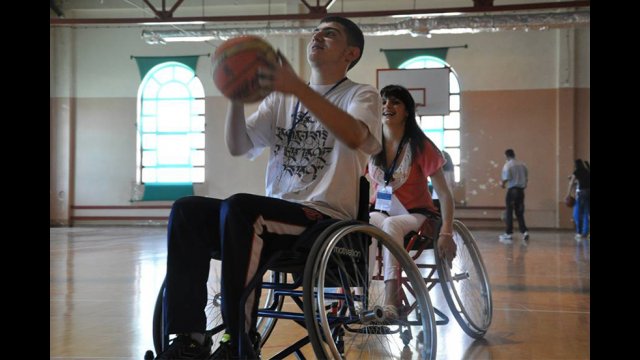 A youth participant goes for the shot during wheelchair basketball. 