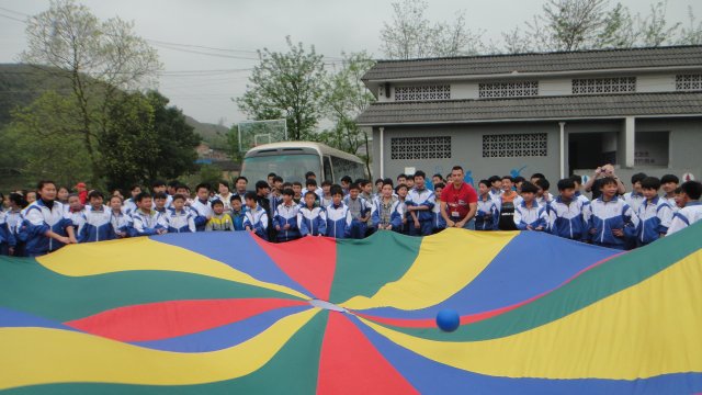 Chinese youth enjoy playing a parachute game with the Americans.