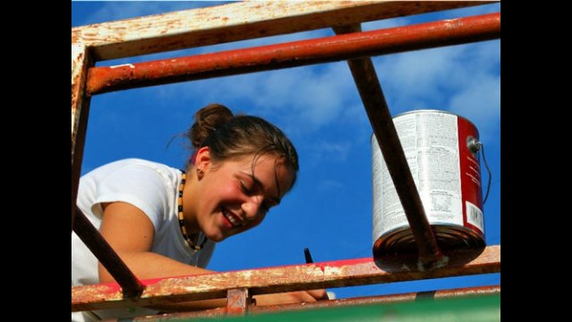 An A-SMYLE student helps improve a local playground as a community service project.