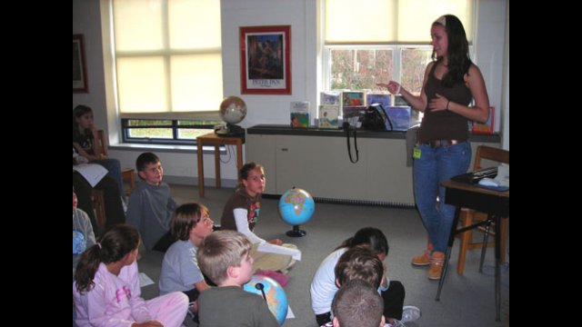 An A-SMYLE student gives a country presentation to American elementary school students.