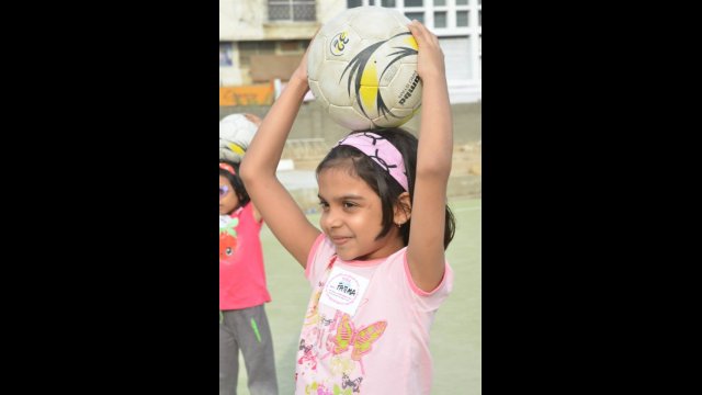 Another young soccer player awaits instruction during a clinic