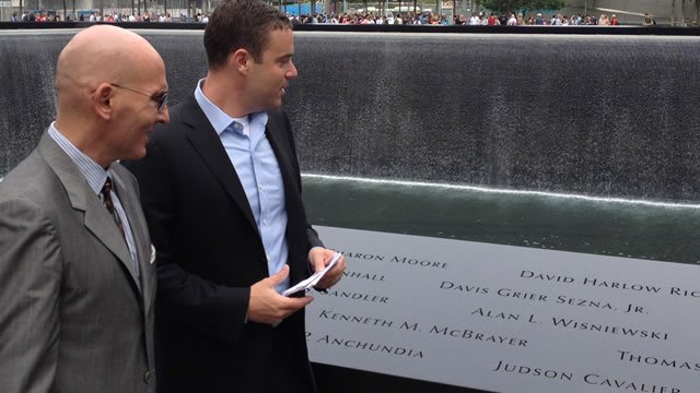 The Board and a group of Fulbrighters visit the names of two Fulbrighters killed in the 9/11 attacks; David Harlow Rice (top right on wall) was a 1995 U.S. Student to Zimbabwe and Christian Adams was a 1988 Visiting Student from Germany.