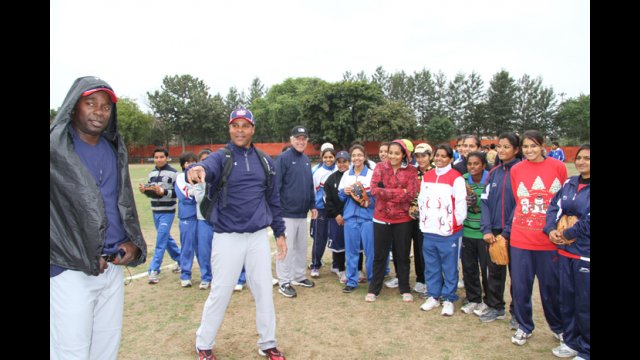 Barry Larkin, Joe Logan, and young athletes in India participate in pre-clinic demonstrations.