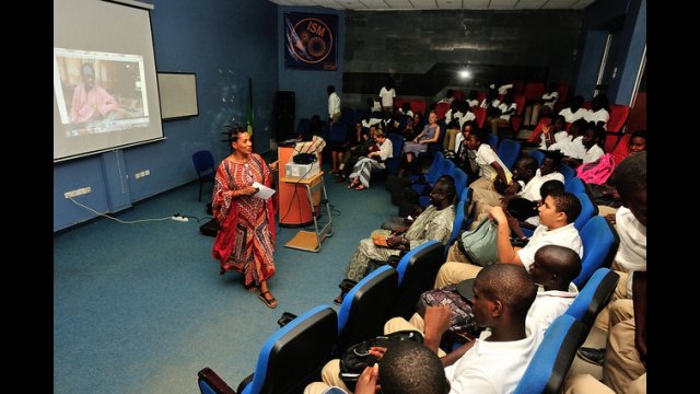 “Next Stop: Brooklyn/Dakar” (2012) between ImagiNationAfrika in Senegal and the Brooklyn Children’s Museum. An auditorium of students participates in a conference call to connect with their peers in Brooklyn.