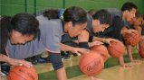The Brazilian visitors work on dribbling by performing one-handed push-ups. The Brazilian visitors work on dribbling by performing one-handed push-ups.