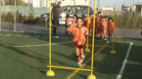 Cypriot children run drills to improve strength and agility during soccer practice