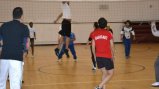 The female volleyball coaches take part in a friendly game with Americans. 