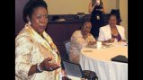 Mariama Sesay from Sierra Leone and Sylvianne Valmont from Seychelles listen to Representative Sheila Jackson Lee at the U.S. Capitol.