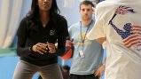 Swin Cash shares her skills through drills with a young player from England.