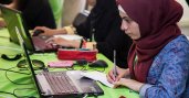 Muslim girl looking at laptop