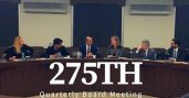 Six adults sitting behind a long round desk with the title "275th Quarterly Board Meeting" layered on top