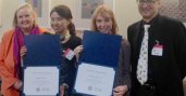 Participants pose with their certificates for completing the program