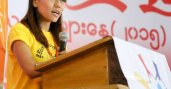 Girl at podium with mic in hand