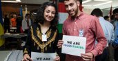 Male and female participant holding signs that say "We are SUSI leaders"