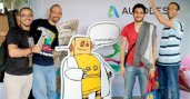 Men holding up with drawings and standing next to Robot poster