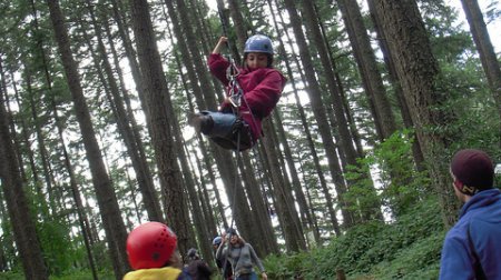 Azima on a ropes course with Mobility International USA in Eugene, OR